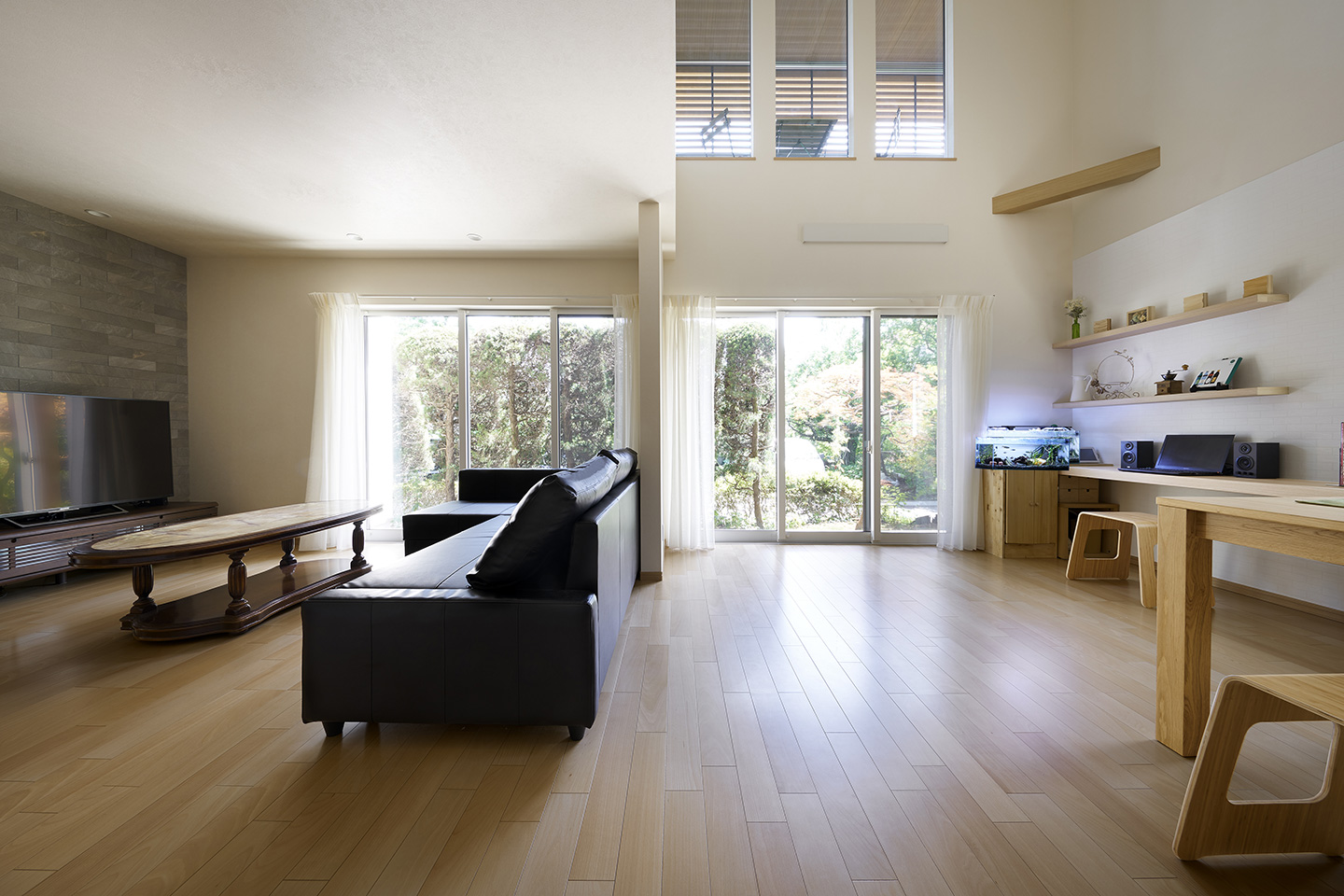 木のルーバーが緑と調和する家